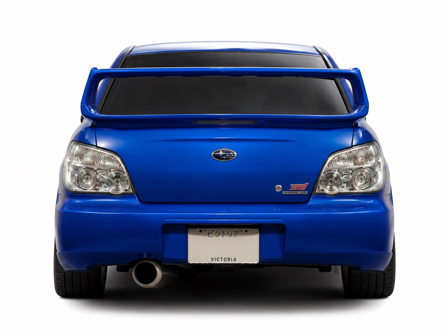 Straight-on studio rear view of a blue Subaru Impreza STI sedan fitted with clear tail lights