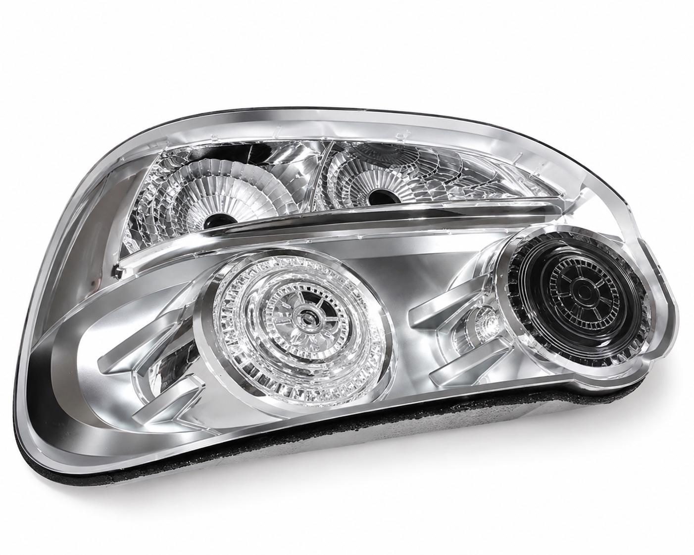 Clear tail light housing on a white background showing chrome reflector bowl detail