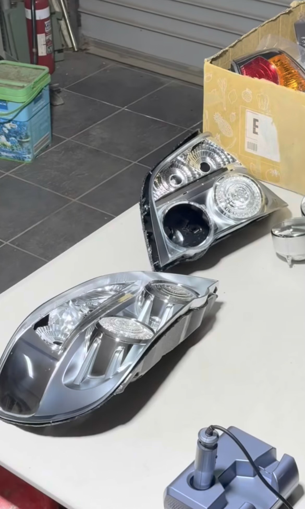 Tail light assemblies split open and stripped back on the bench