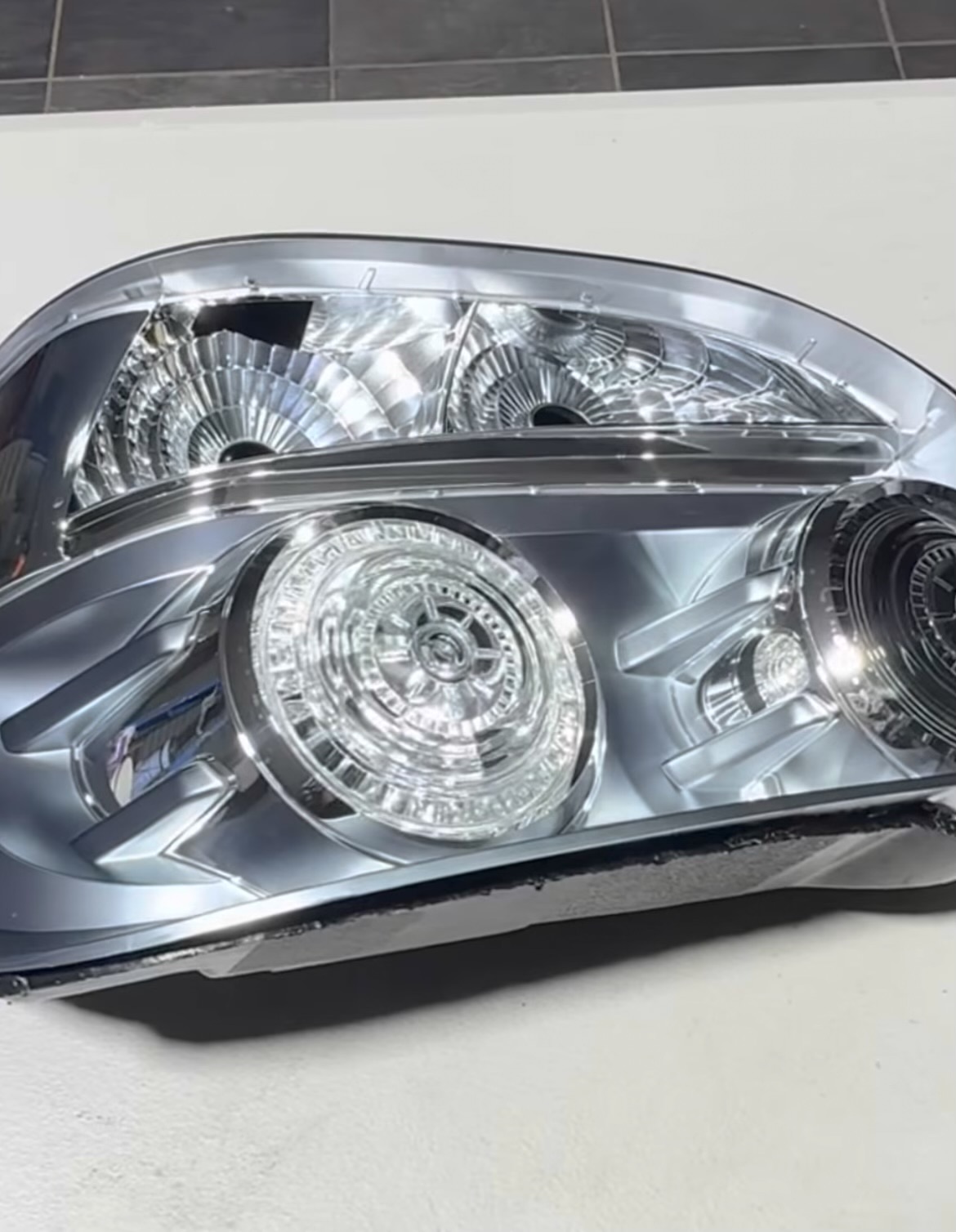 Refinished chrome tail light housing on the workshop bench