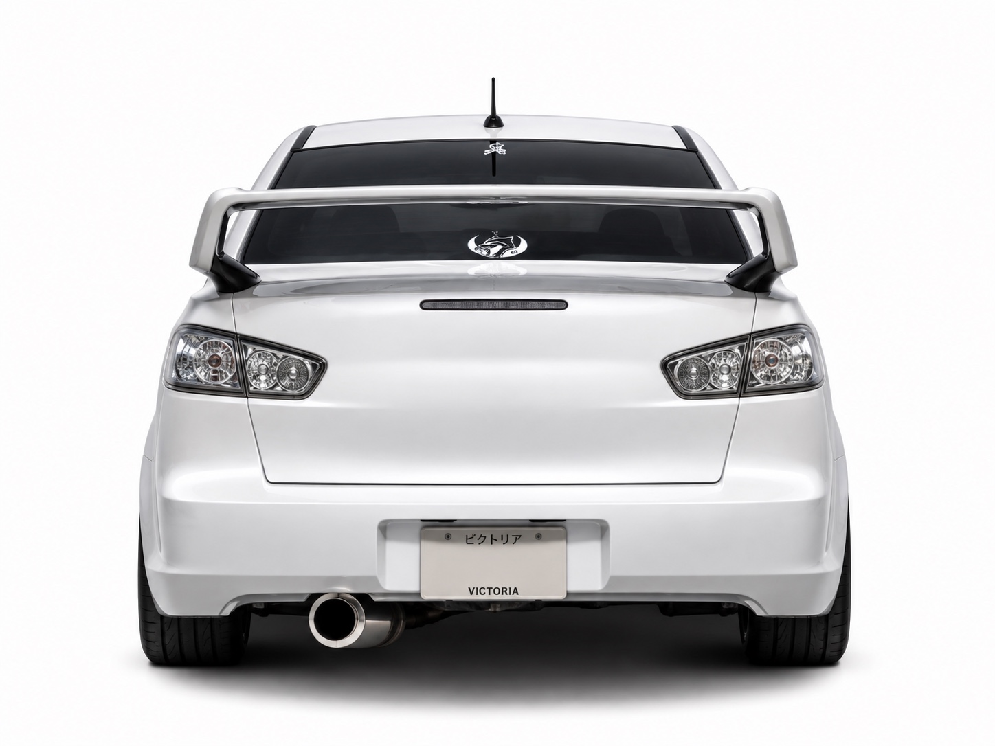 Straight-on studio rear view of a white Mitsubishi Lancer CJ sedan fitted with clear tail lights